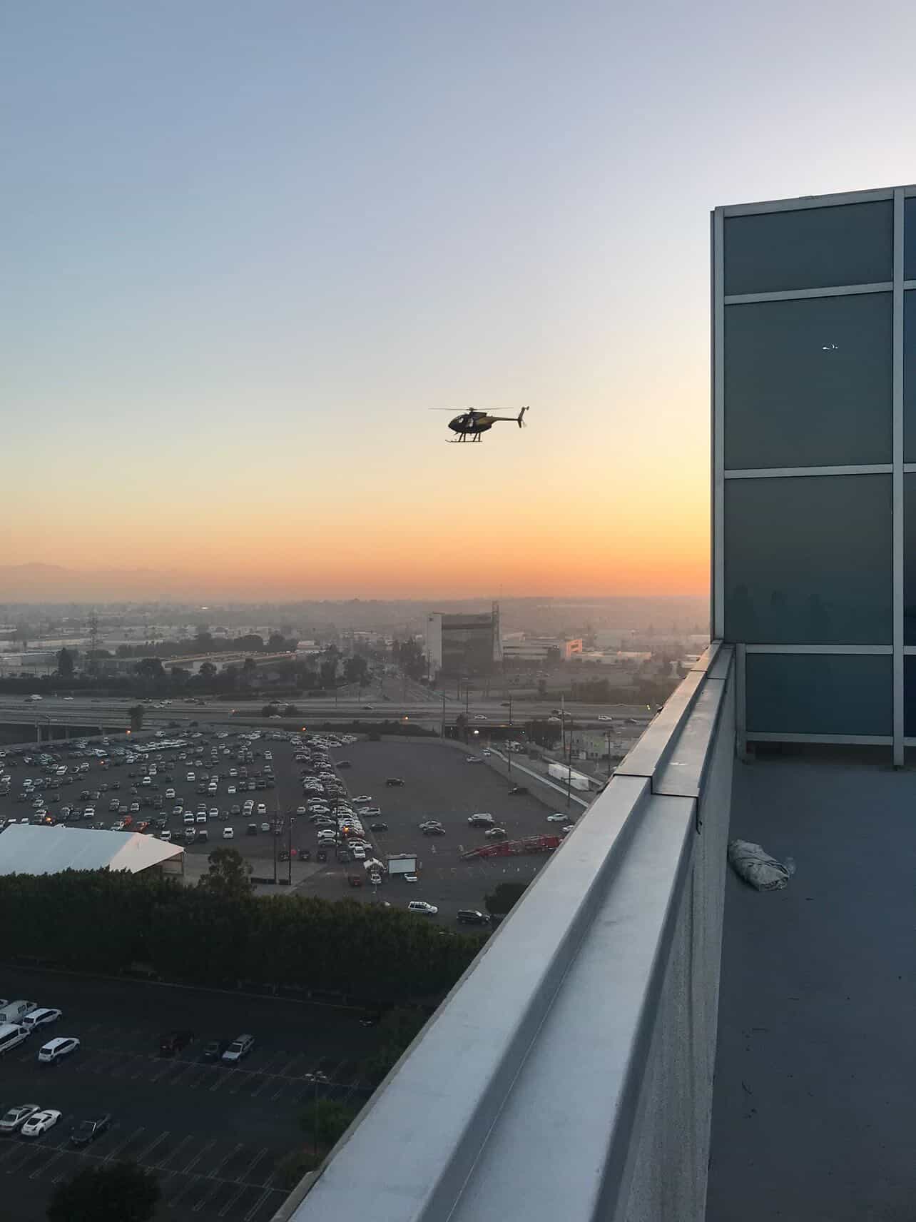 Helicopter over city skyline at dusk