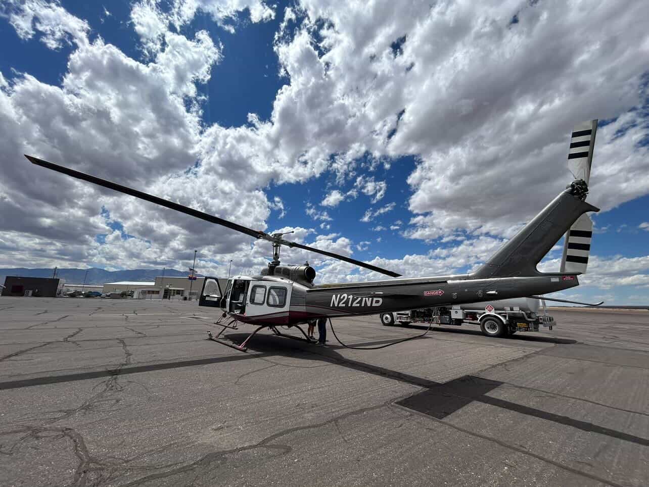 Bell 212 on tarmac with fuel truck at operations base